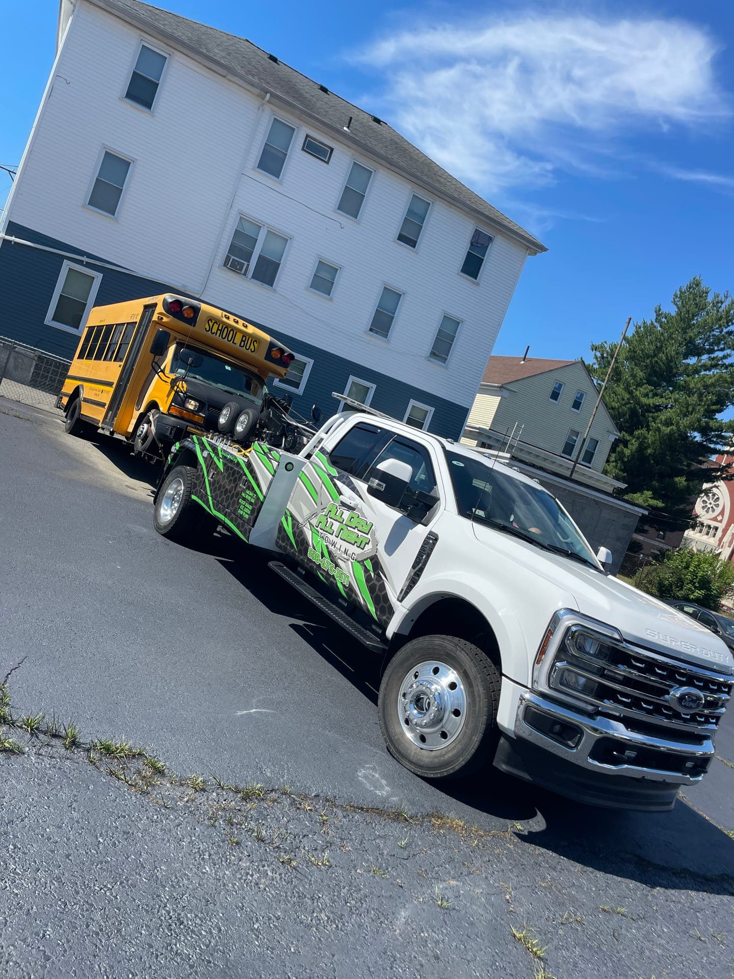 School bus under tow behind the wrecker